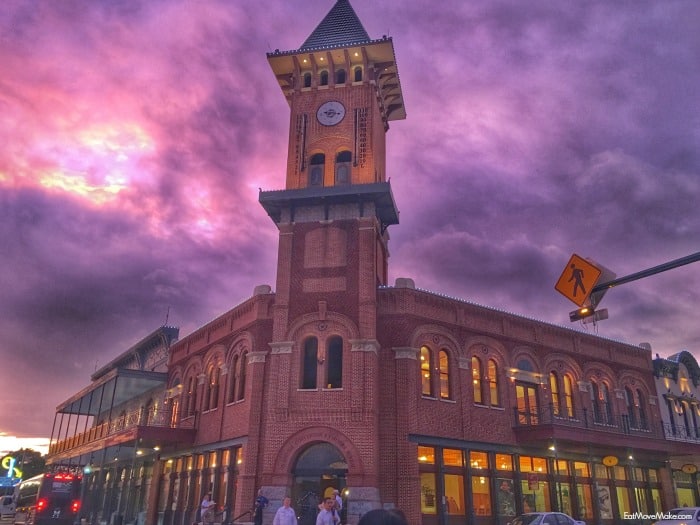 A clock tower in the middle of the street