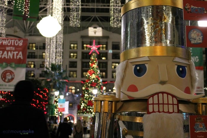 a nutracker in front of Christmas trees