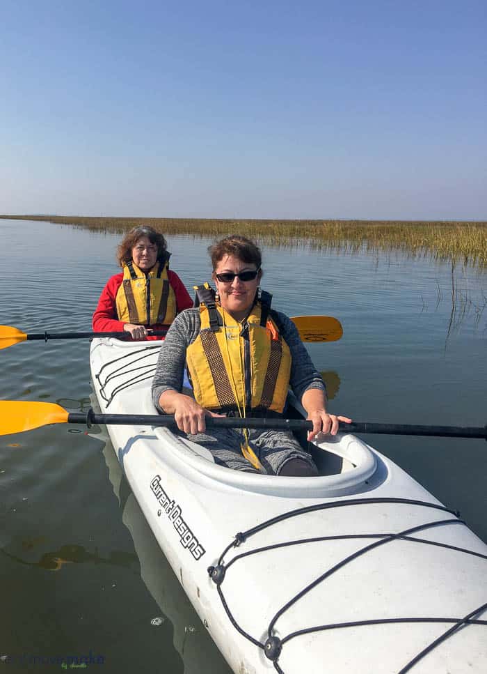 A person sitting in a boat on a body of water