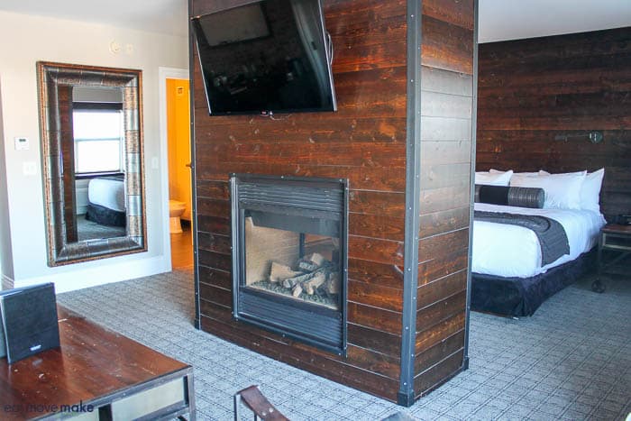 A fire place sitting in a living room with a brick wall