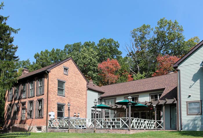 A large brick building with grass in front 