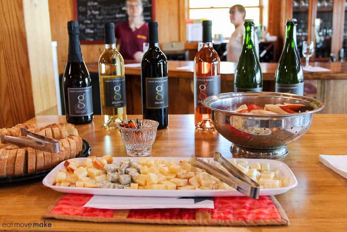 A plate of food and a bottle of wine on a table