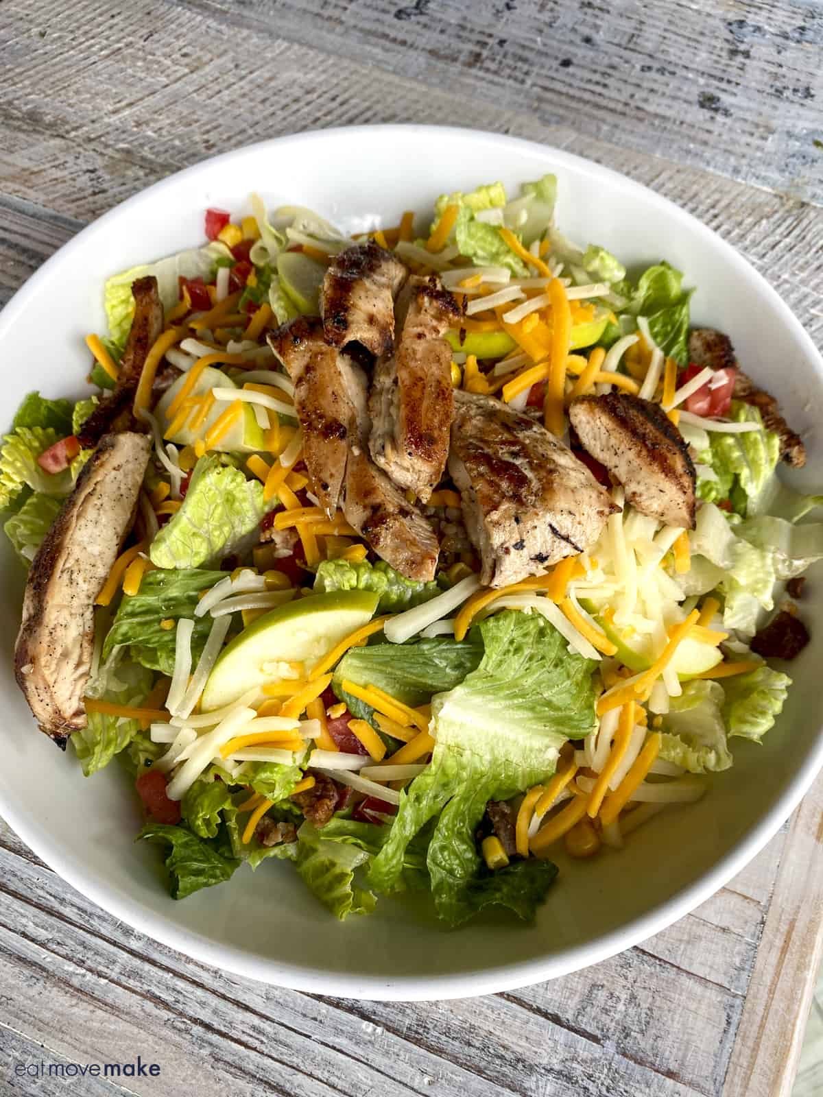 Brew Chop Salad in white bowl with grilled chicken