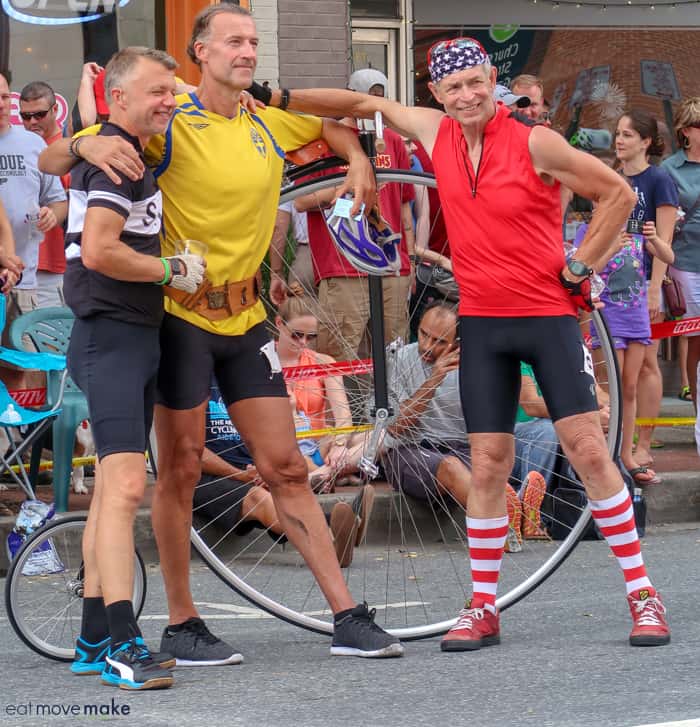 A group of bicyclists standing by their bikes