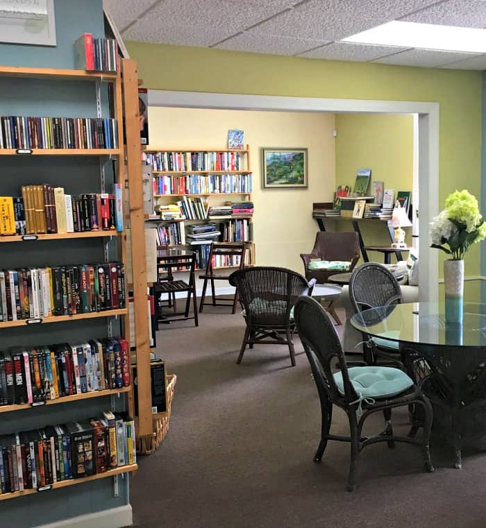 A room with a book shelf filled with books