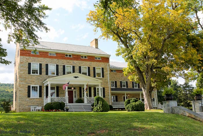 A large brick building with grass in front of a house