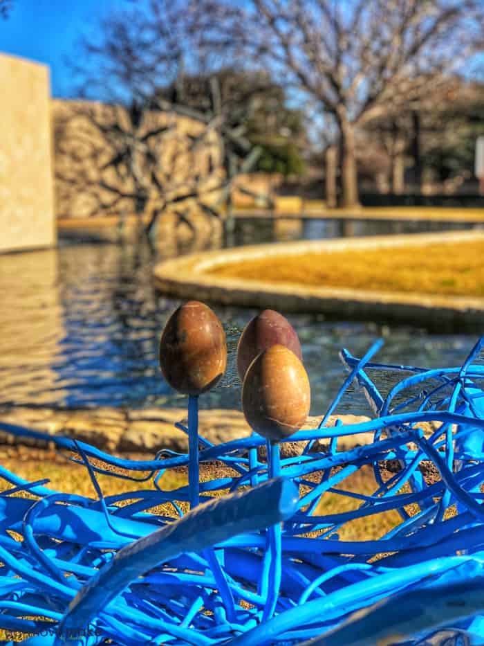 sculpture by body of water