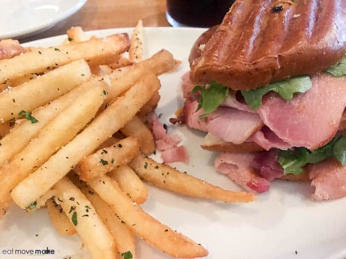 A sandwich sitting on top of a pile of fries