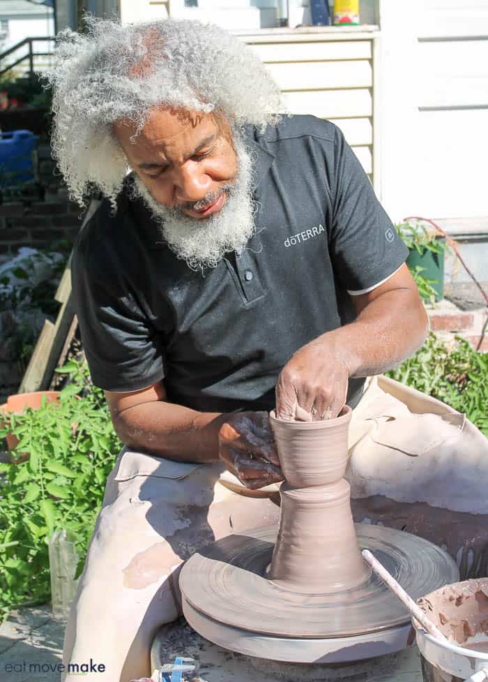 A man sitting at a pottery wheel