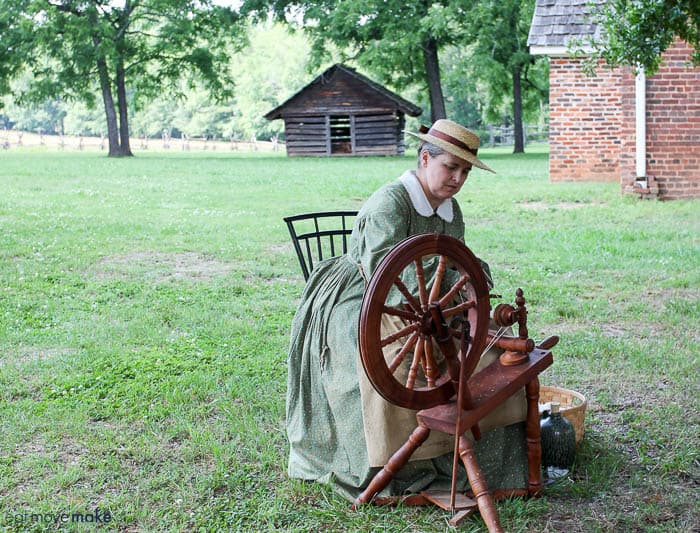 A person using a spinning wheel