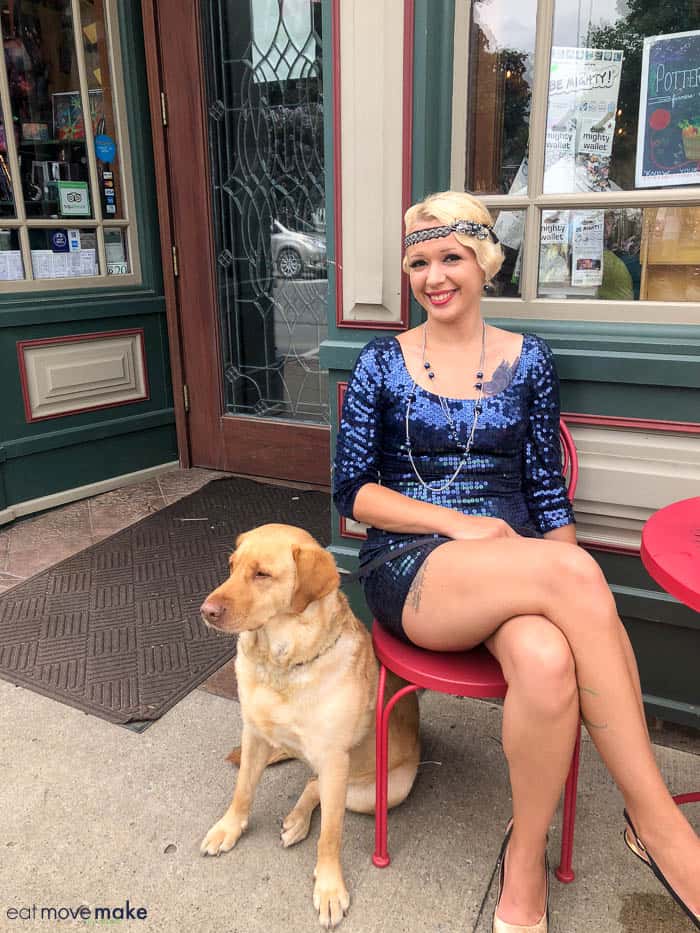 A woman sitting on a bench with a dog