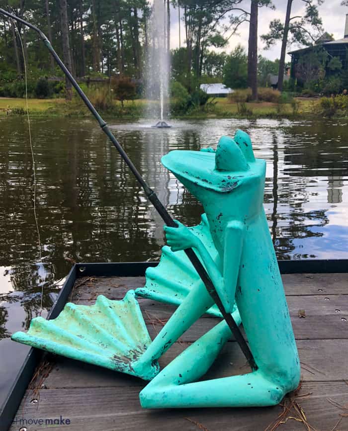 A frog sculpture  by body of water