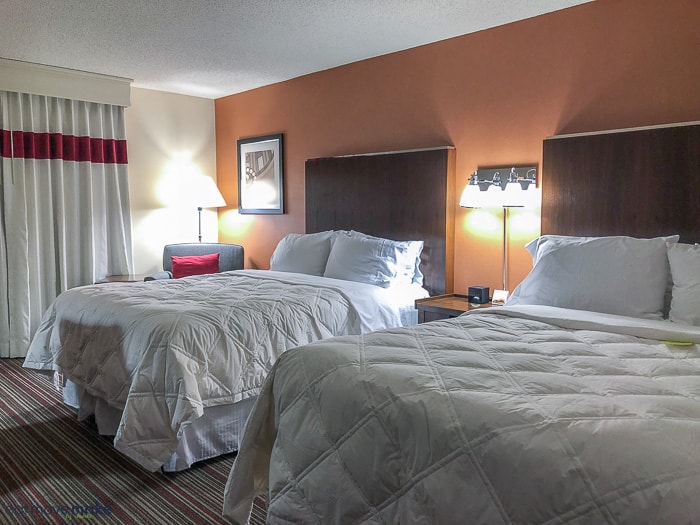 A bedroom with a large bed in a hotel room