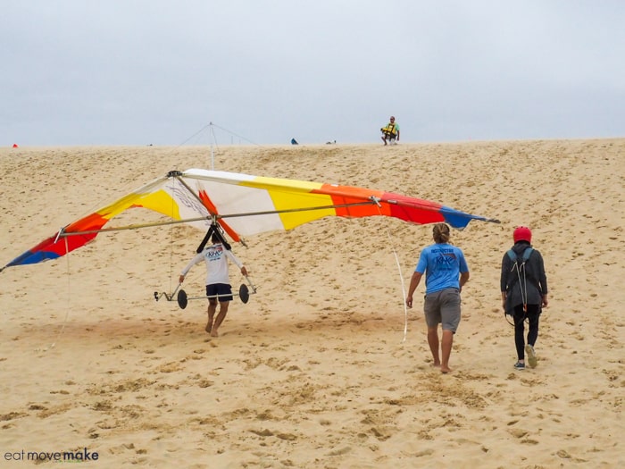 headed up the dune to hang glide