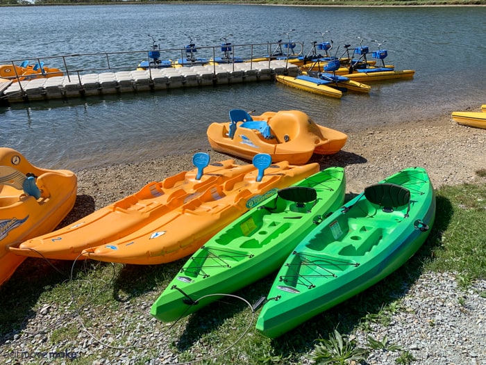 A group of orange and green boats in the water