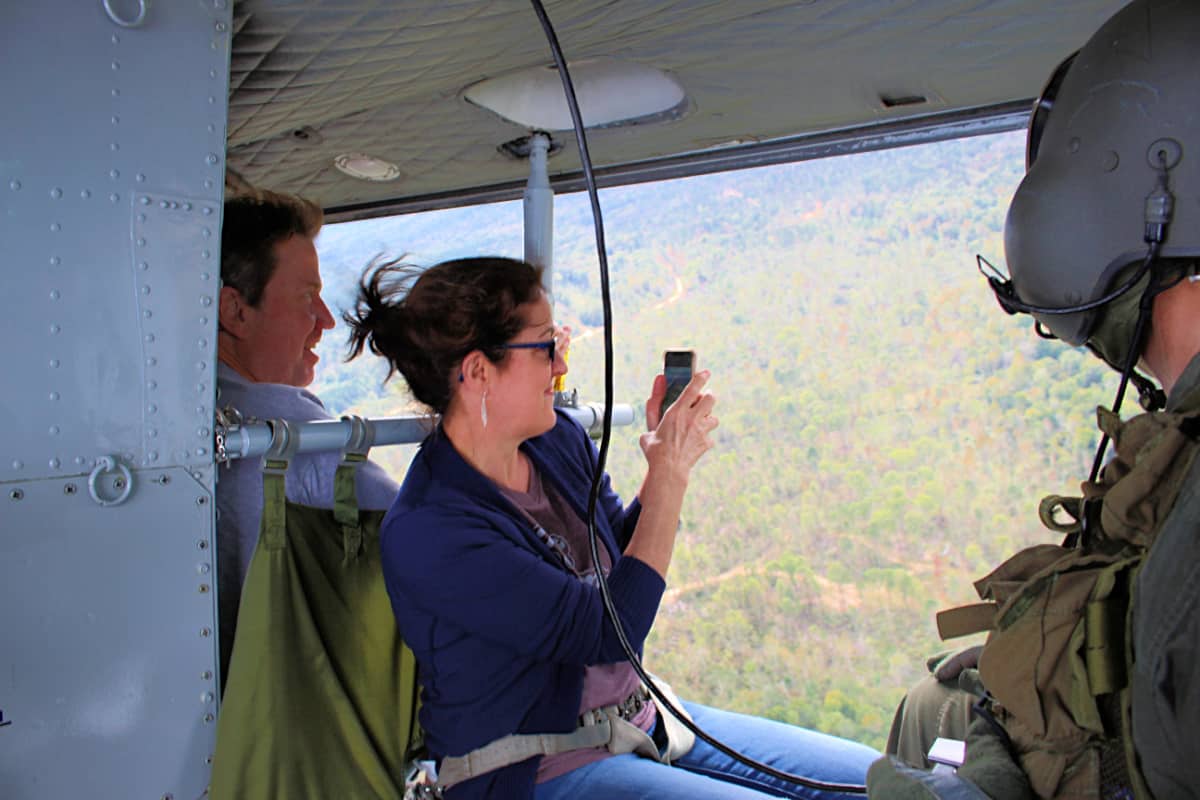 lady taking photos from inside helicopter