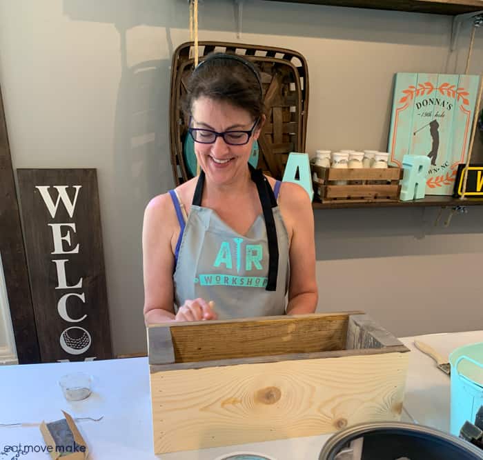 A woman standing in front of a box 