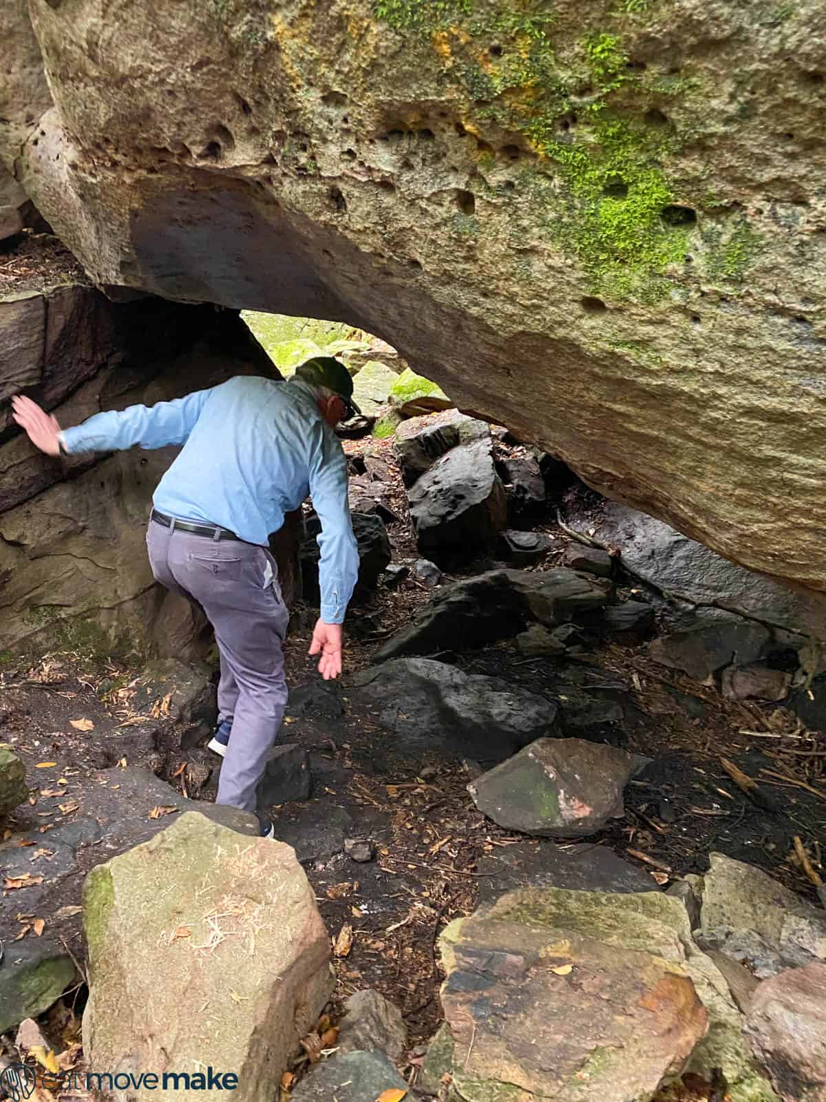 man walking around boulders