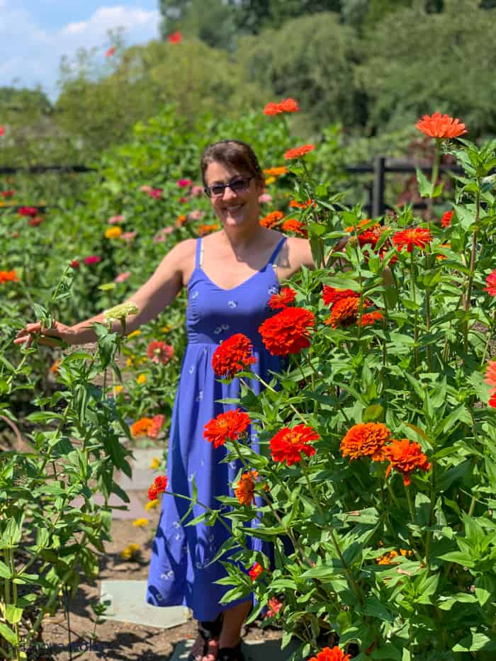 A person standing in front of a flower 