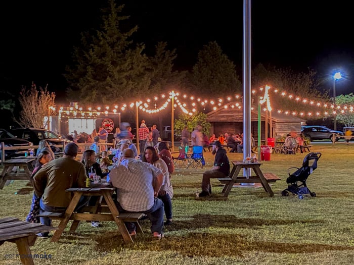 people sitting at picnic tables at Mike's Farm