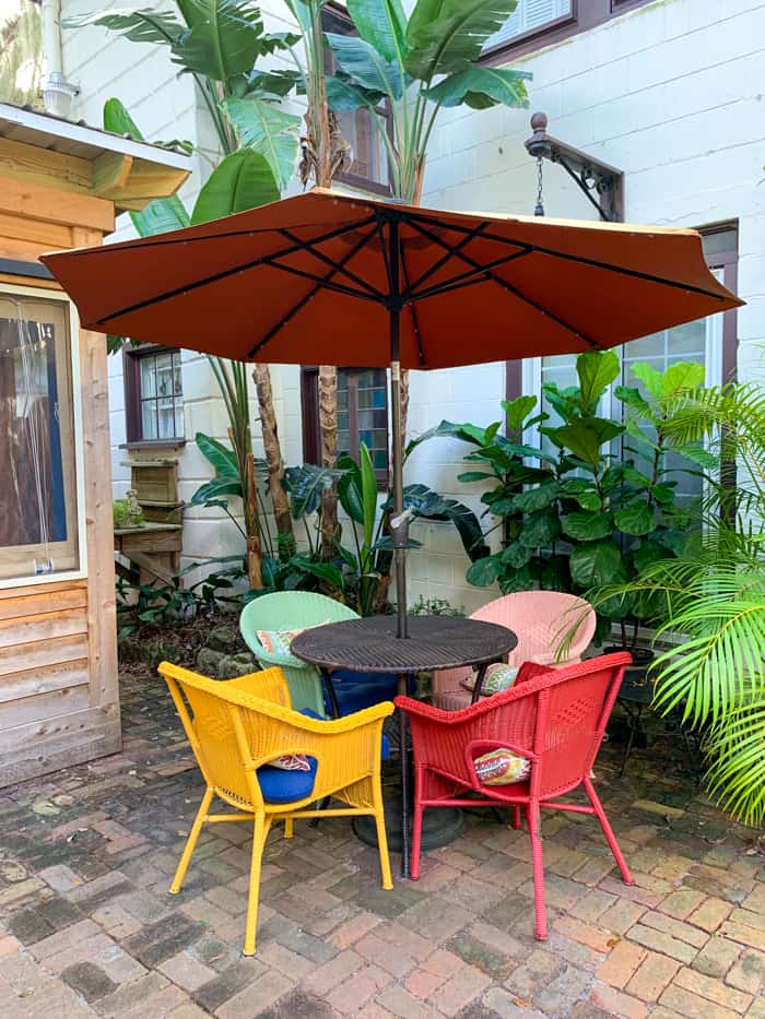 a group of chairs under an umbrella