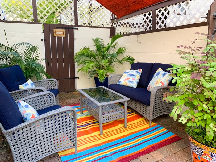 A patio filled with furniture and a large window