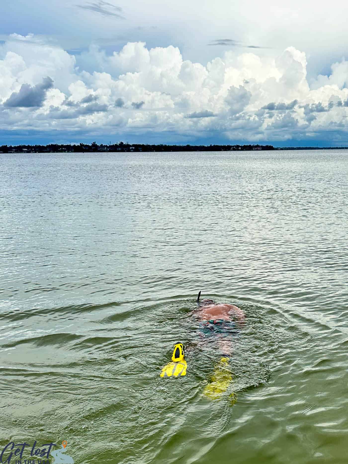 man snorkeling in water.