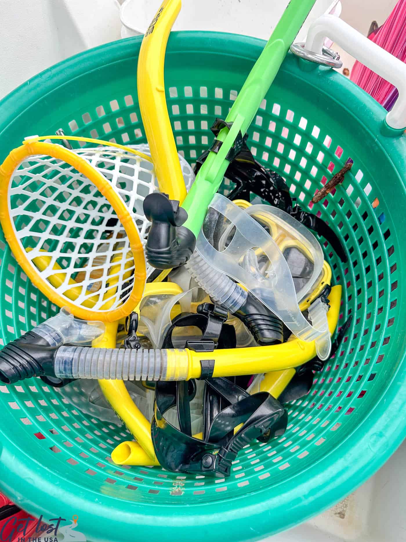 snorkeling gear in green basket.