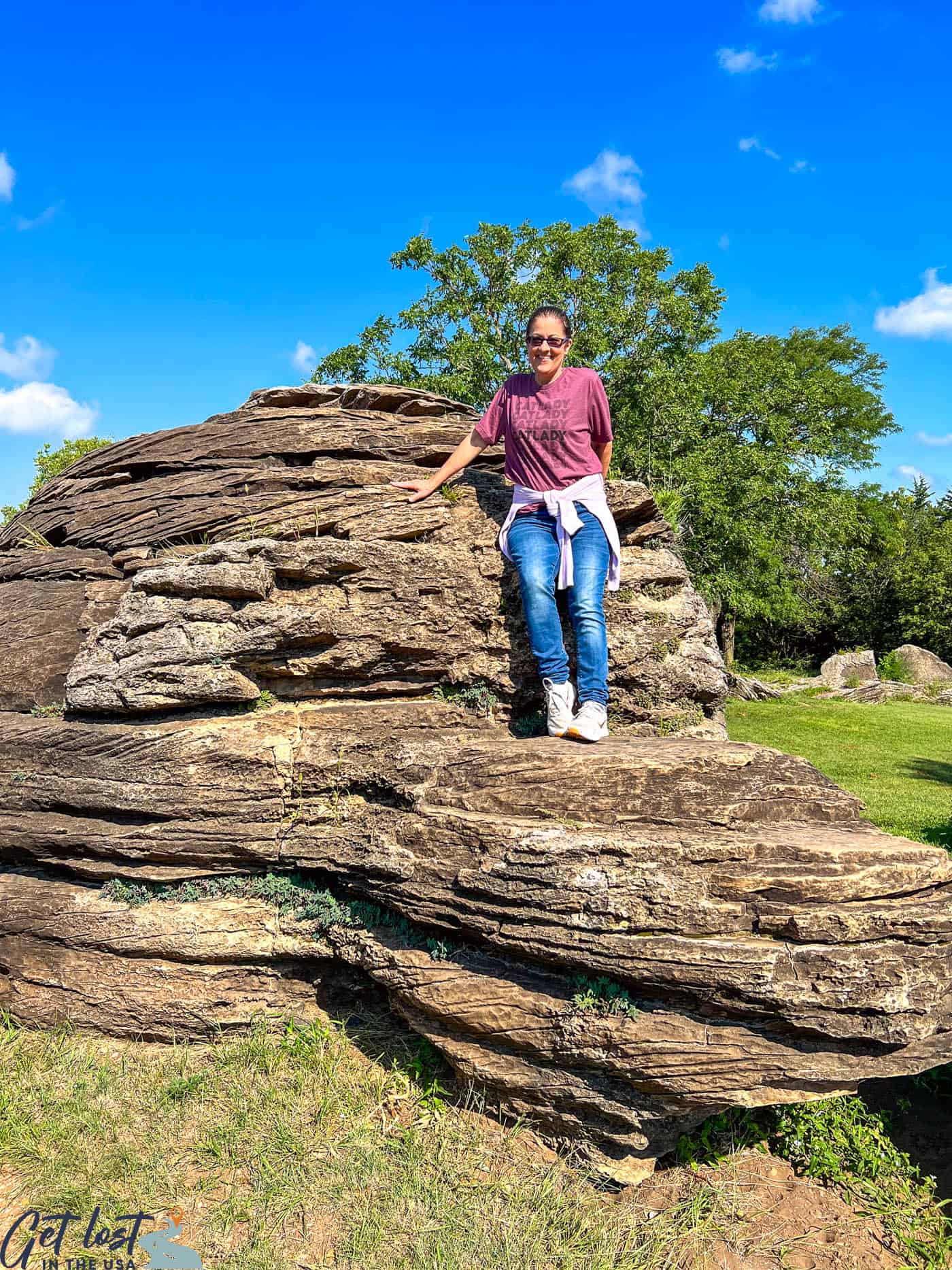 lady standing on rocks at Rock City Kansas.