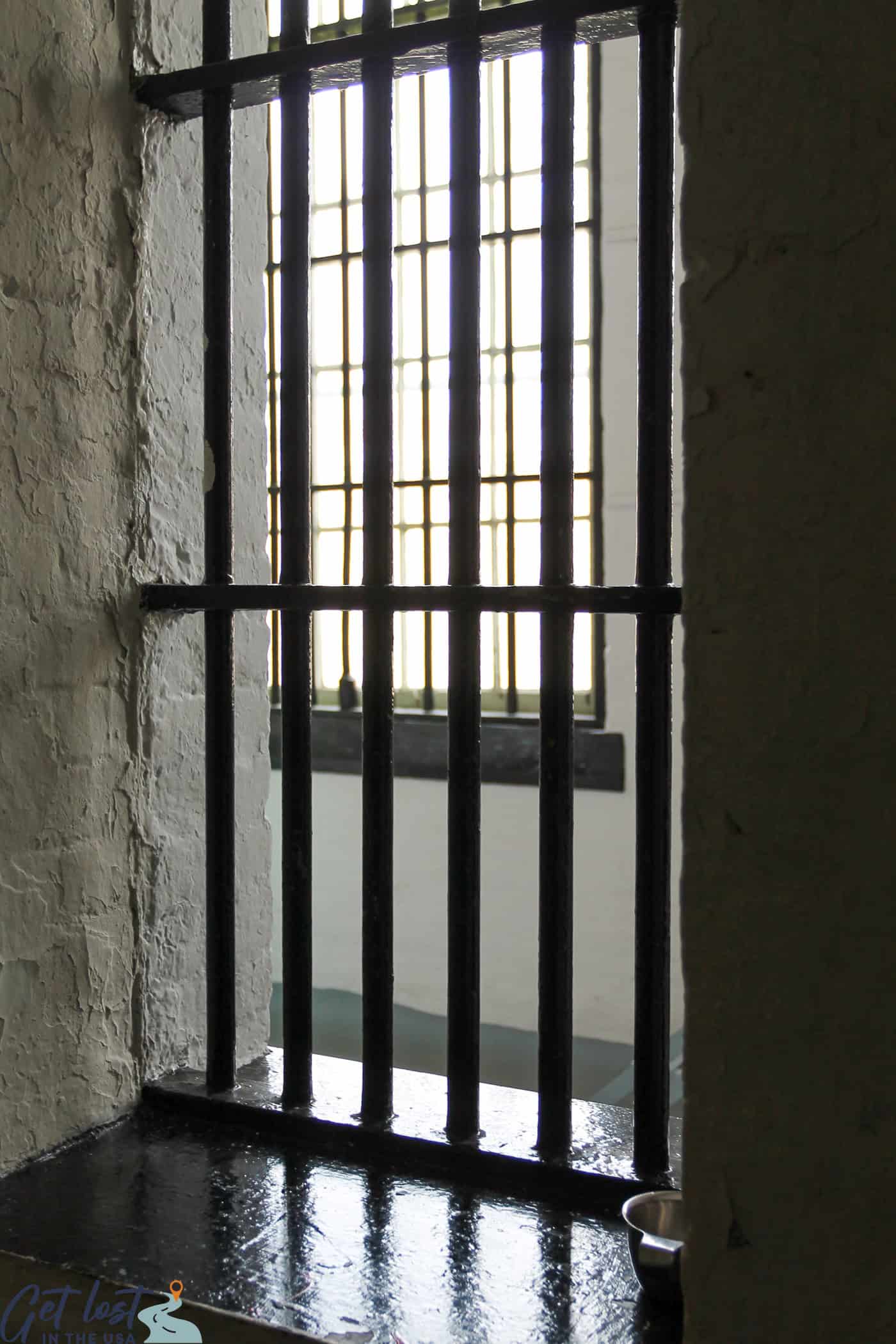 photo looking out from behind bars in new annex of Old Jail.