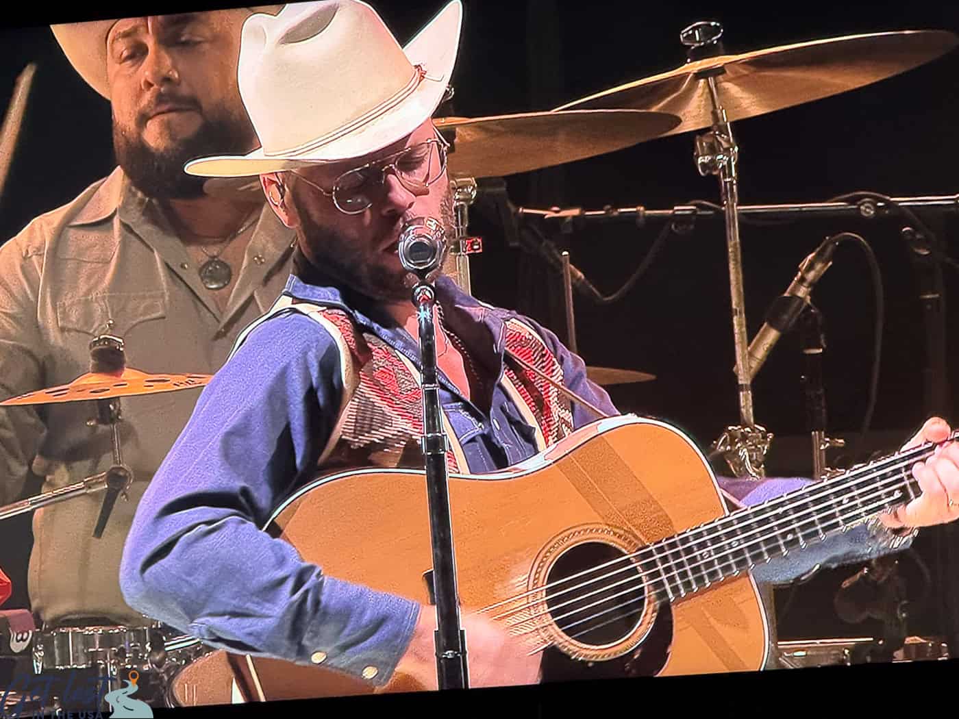 Charlie Crockett playing guitar and singing at Walmart AMP.