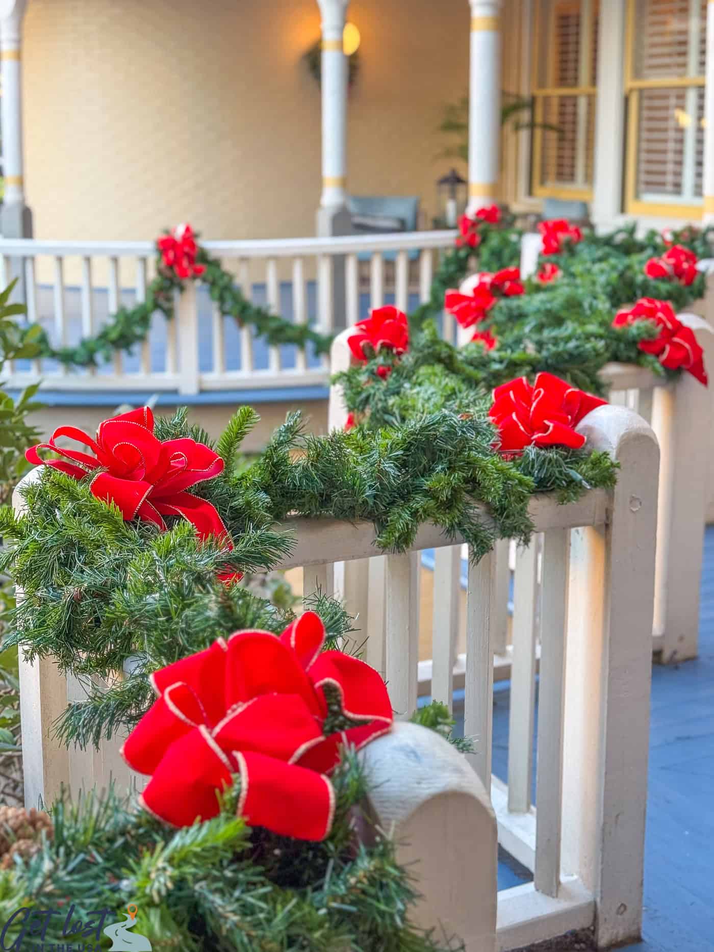 garlands and red bows along railing.