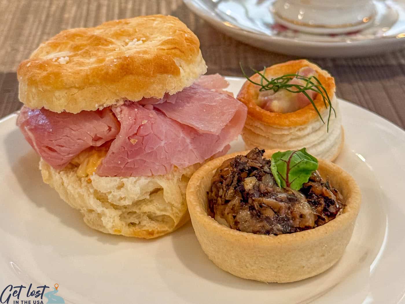 ham biscuit, mushroom tart on plate.