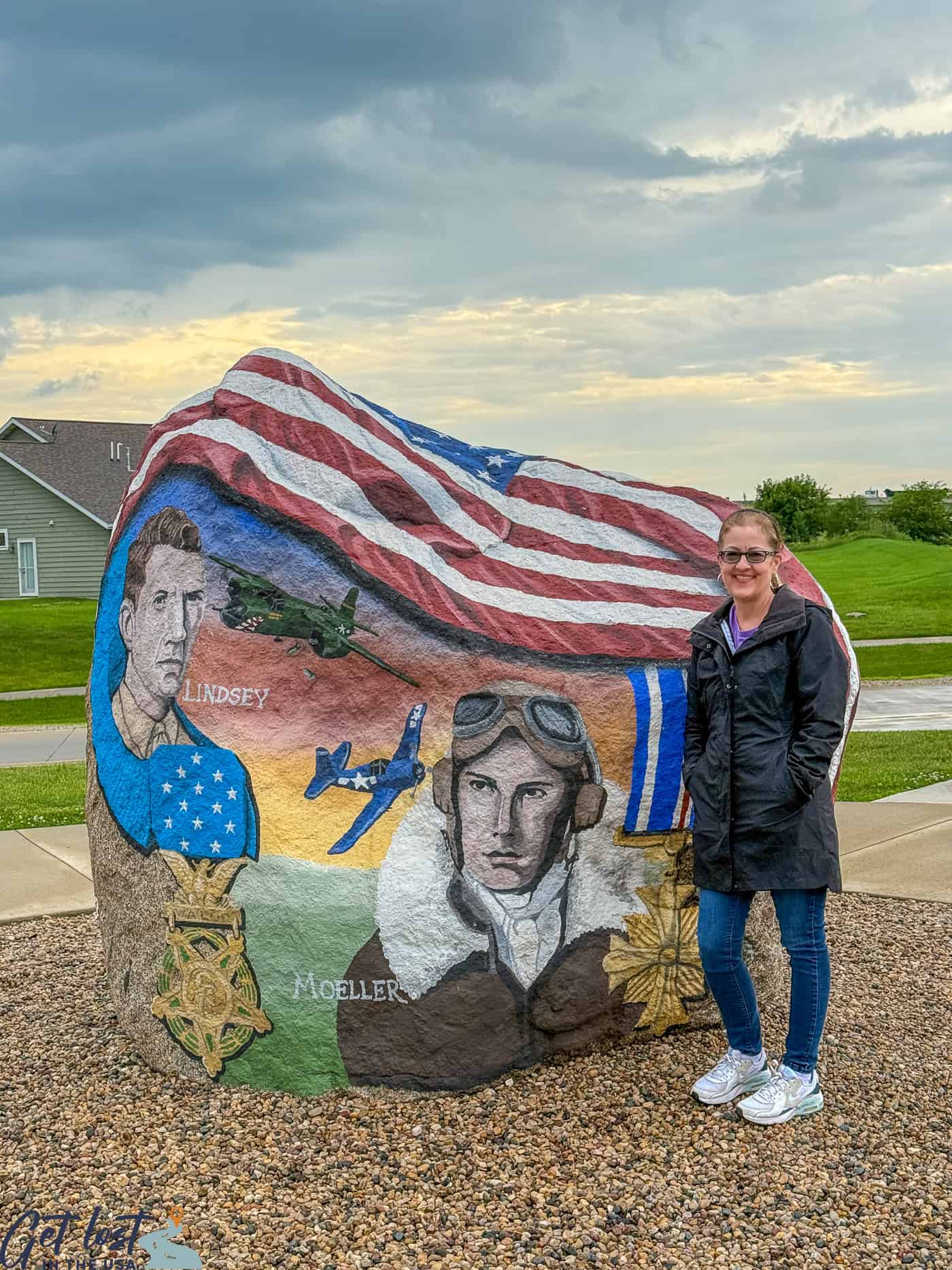 lady standing by Webster County Freedom Rock.