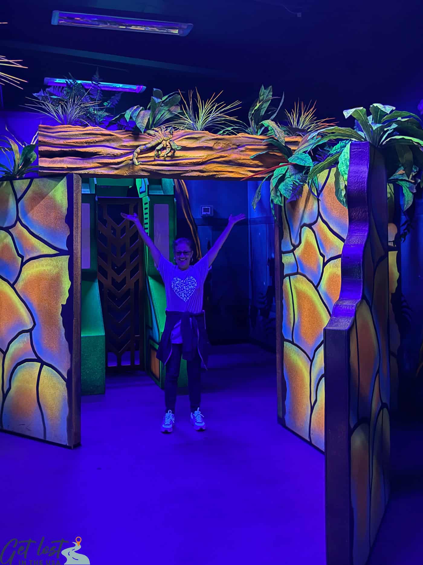 lady standing with arms up in lazer zone of Fort Frenzy.