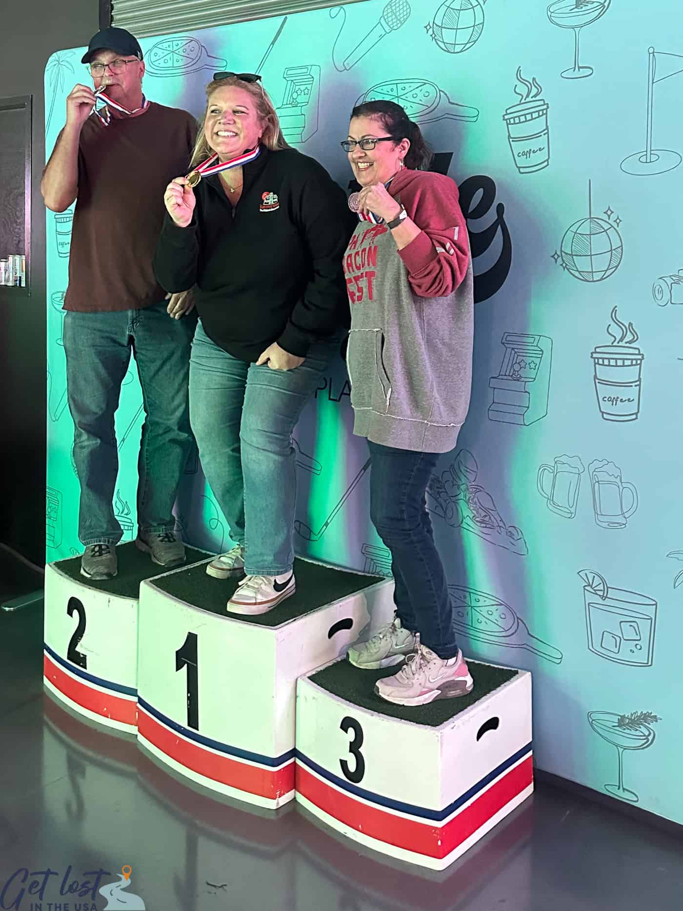 people holding medals on award stand.