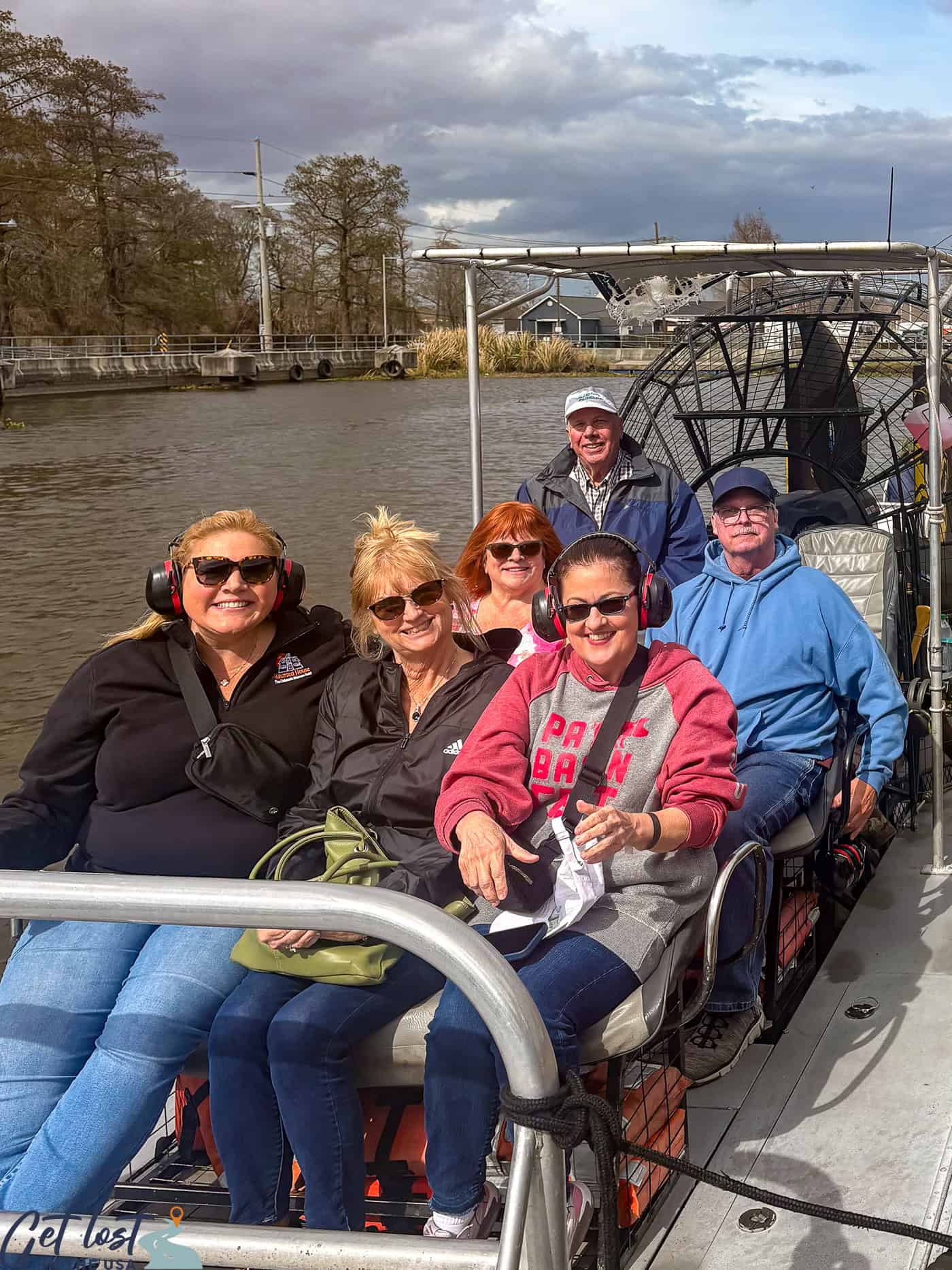 people sitting in an airboat.
