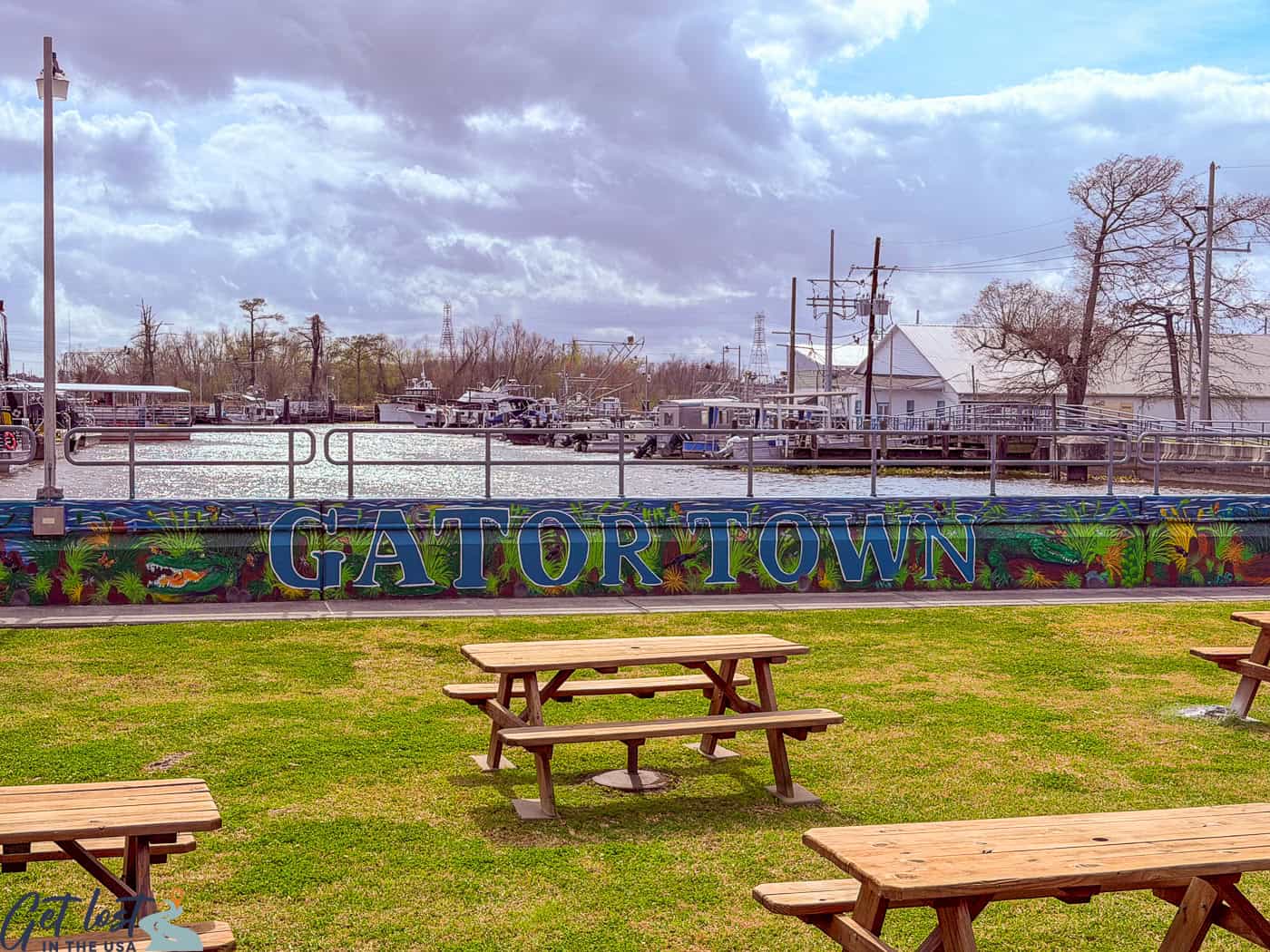 picnic tables in foreground of Gatortown sign.
