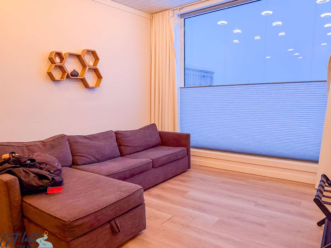 Cube suite sitting area at Borealis Basecamp with floor-to-ceiling windows overlooking the ridge.