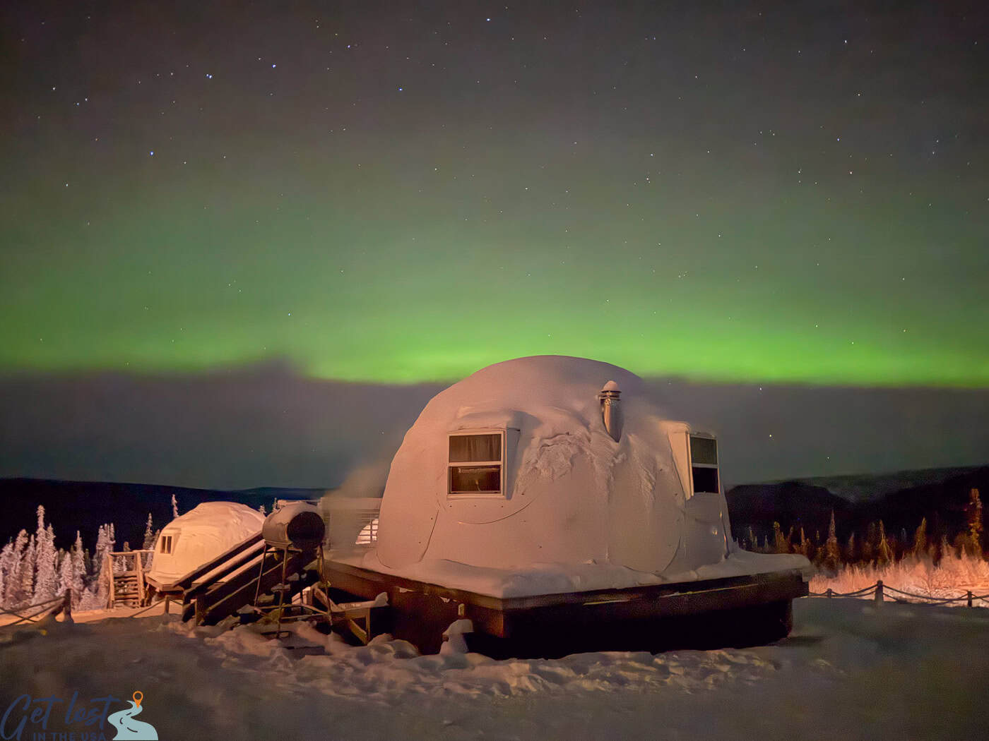 Borealis Basecamp northern lights over igloo.