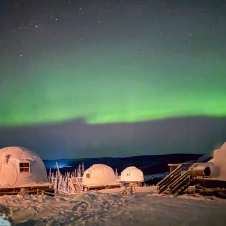 Borealis Basecamp northern lights over igloos.