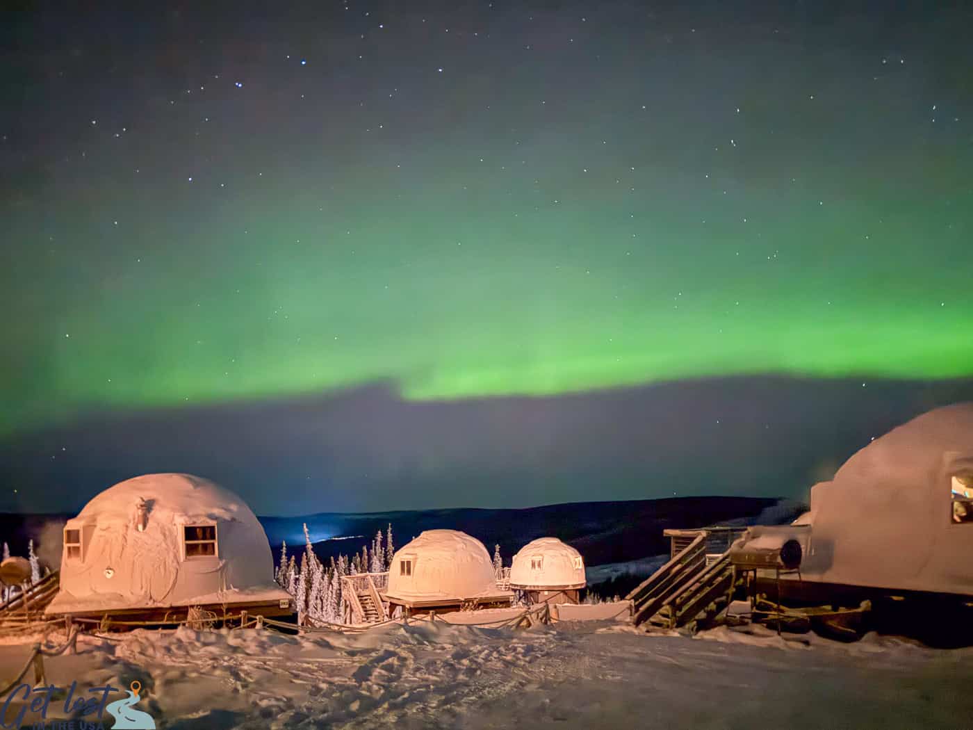Borealis Basecamp northern lights over igloos.