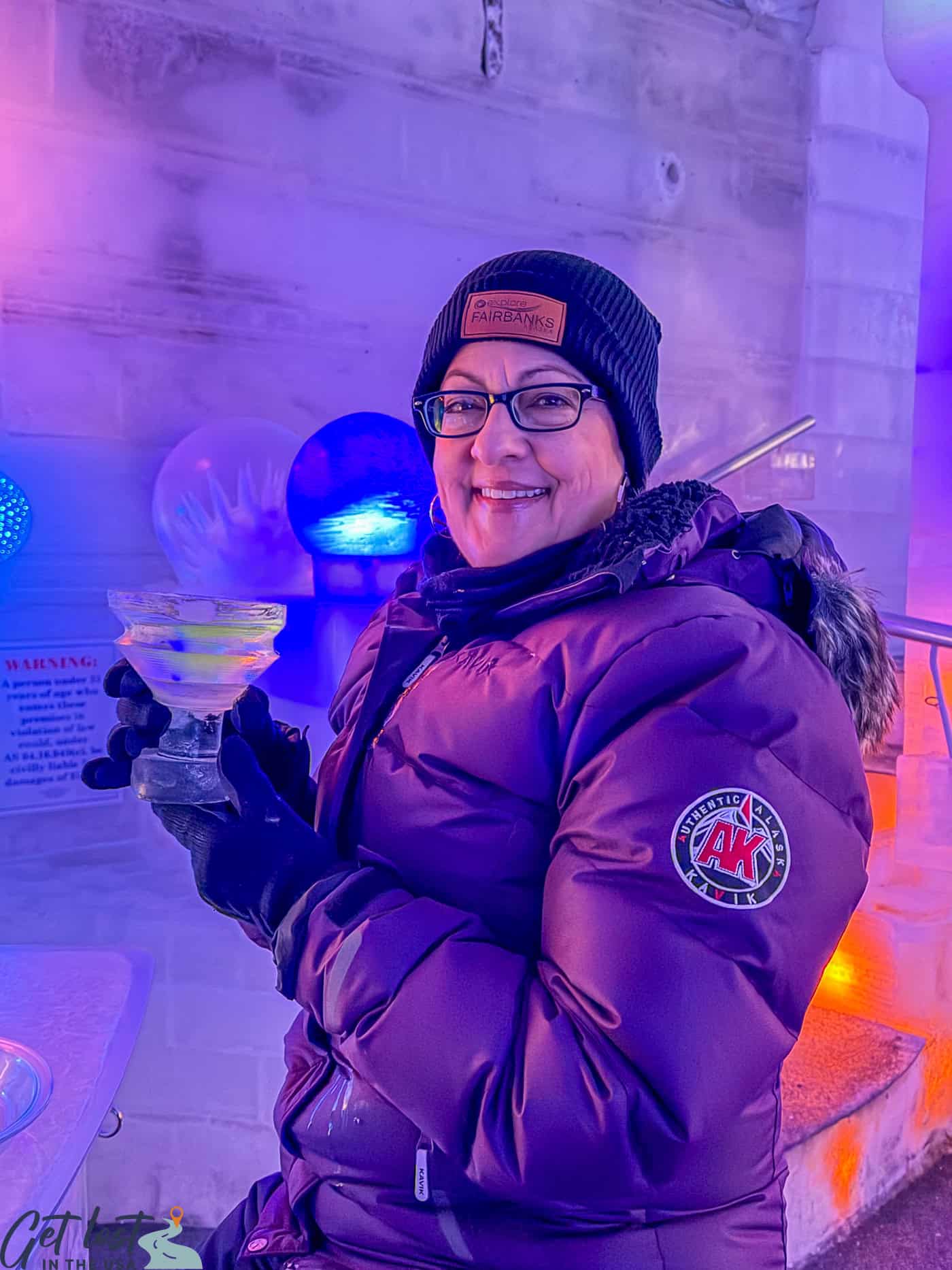 lady holding ice cocktail in ice museum.