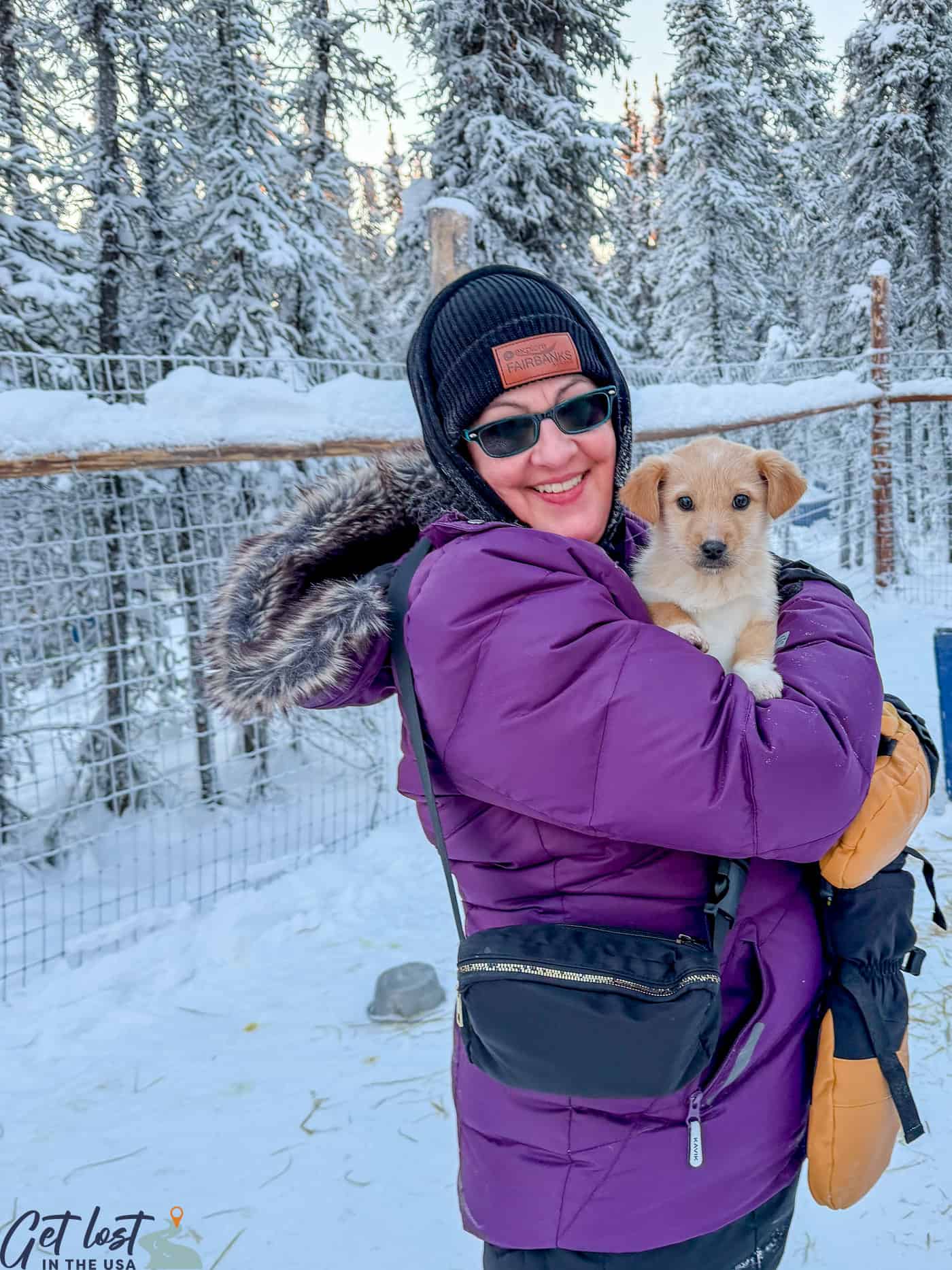 lady holding puppy at Borealis Basecamp.
