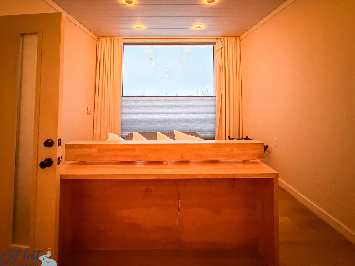 Bedroom window in a Borealis Basecamp cube suite with adjustable shades for northern lights viewing.