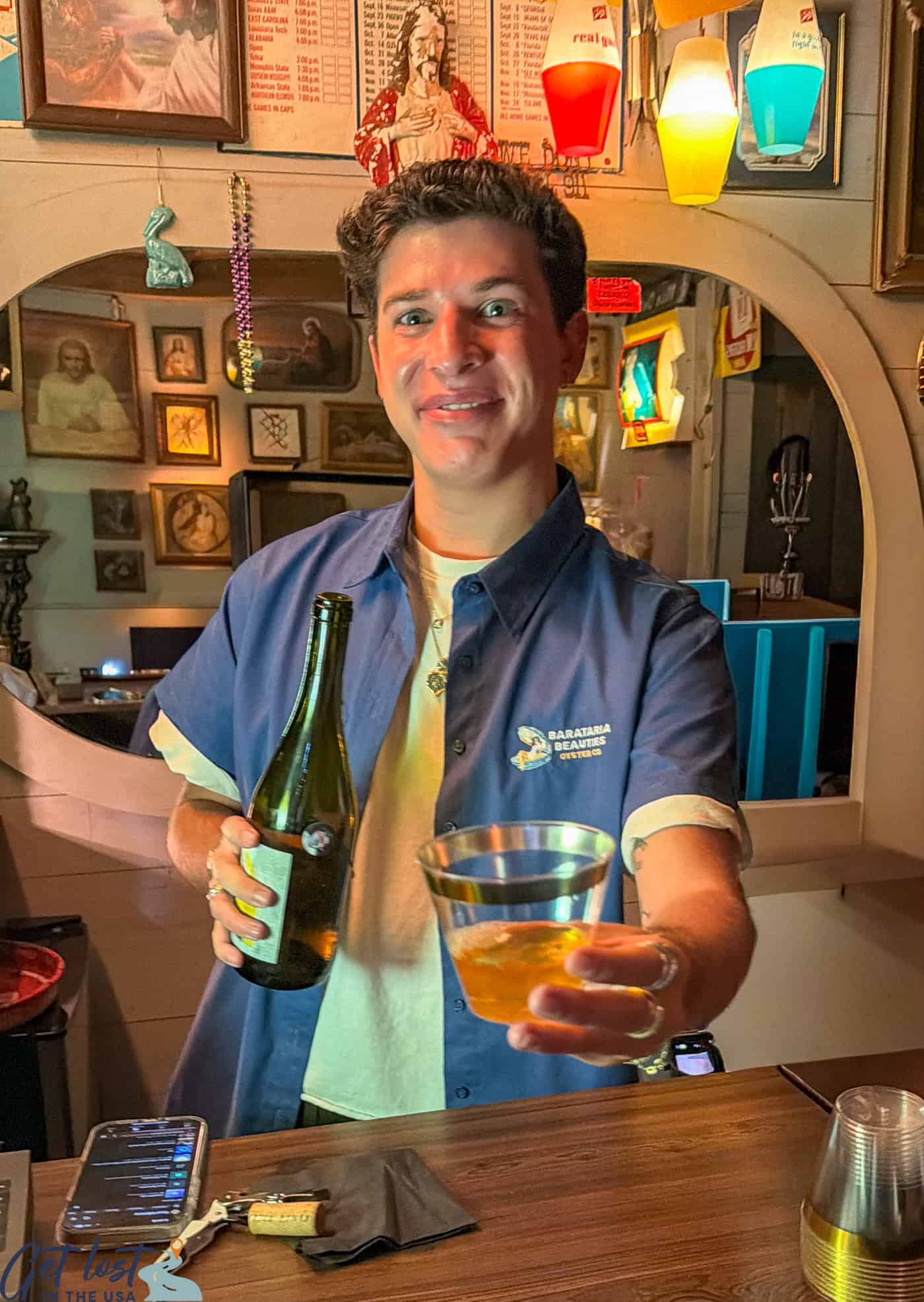 bartender holding a cocktail glass in the Jesus Bar.