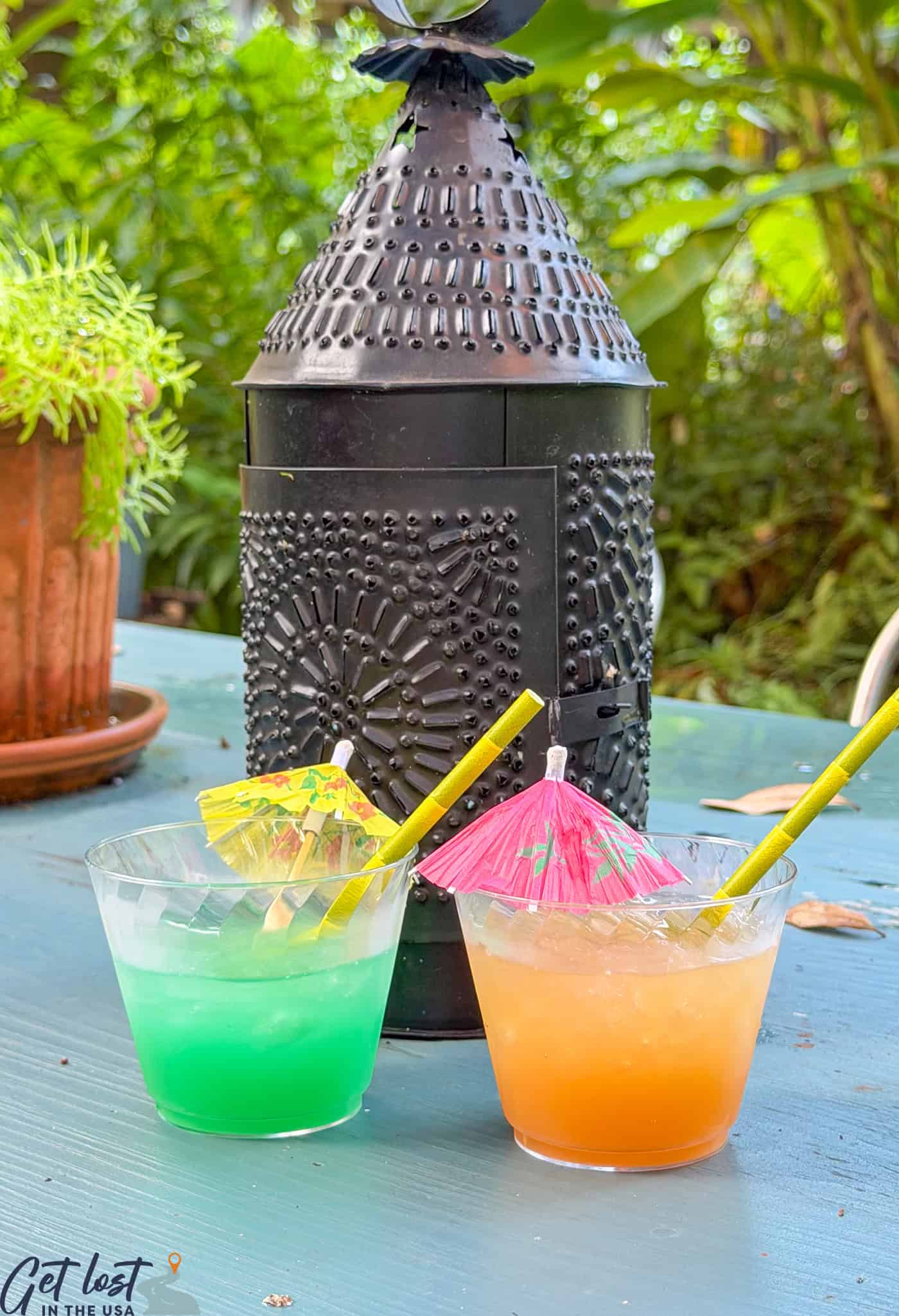 green and orange cocktails on table.