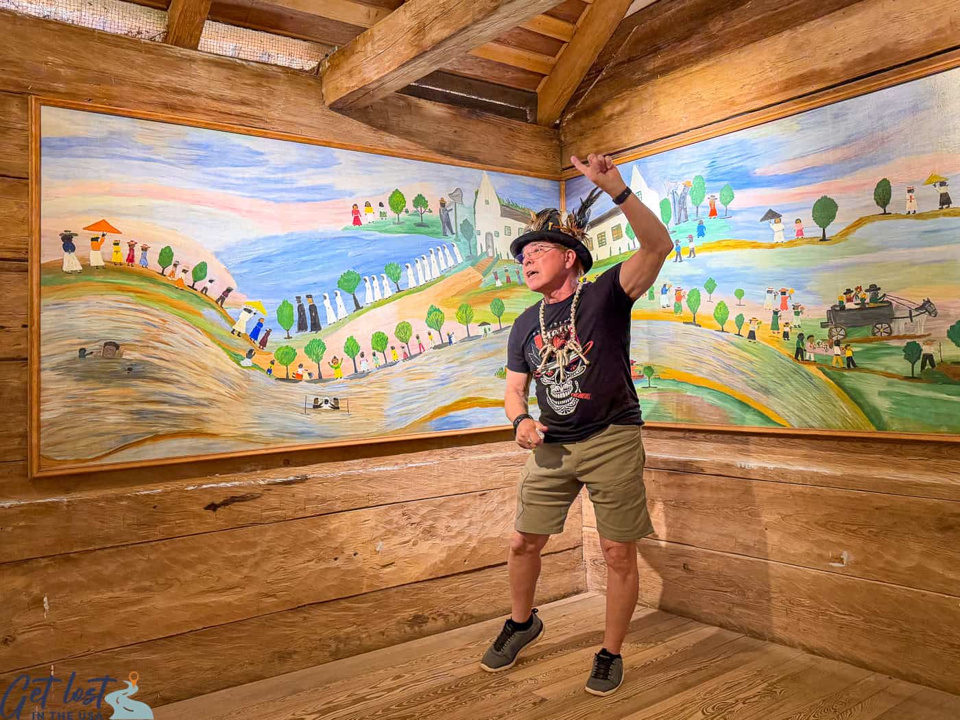tour guide standing in front of Clementine Hunter murals.