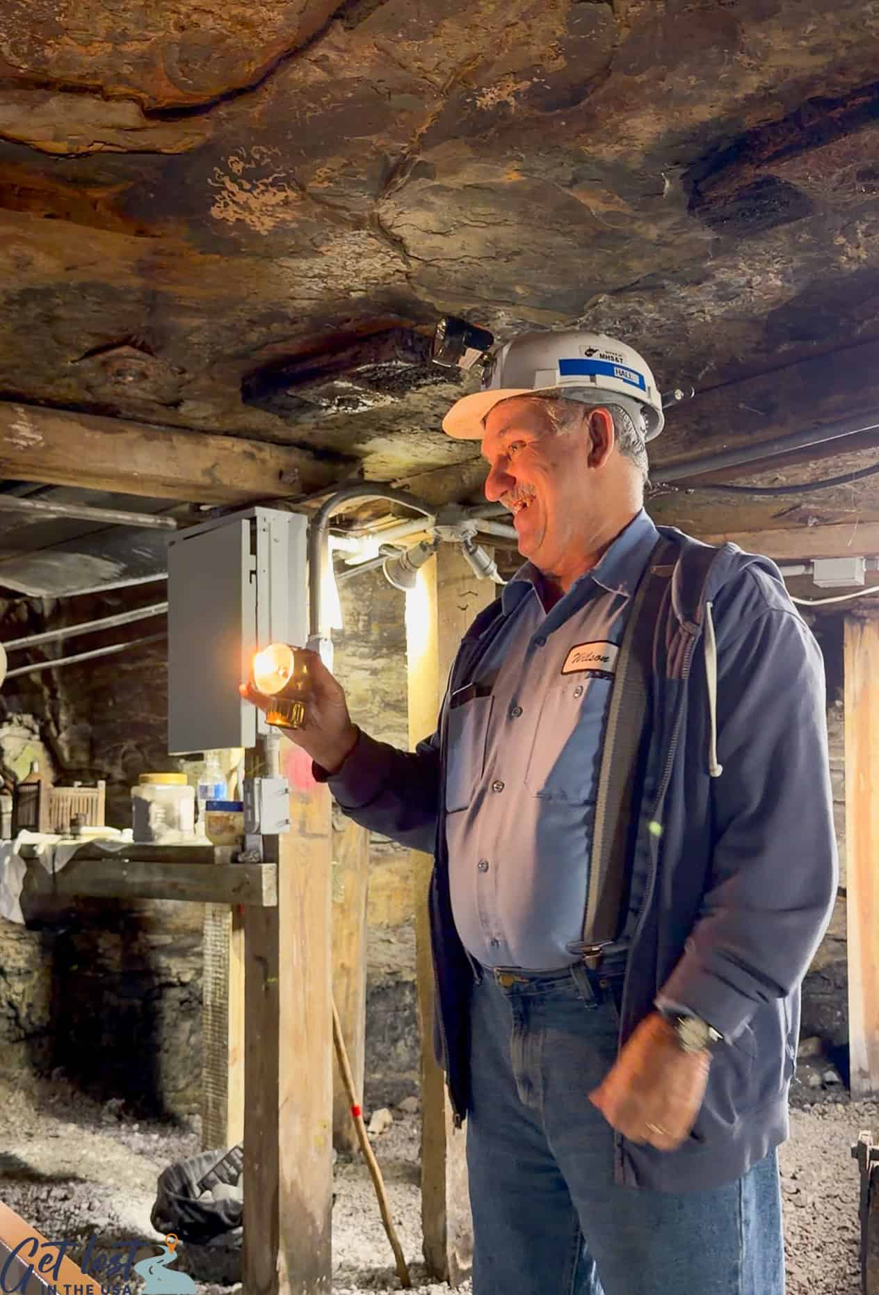 tour guide demonstrating carbide lamp.