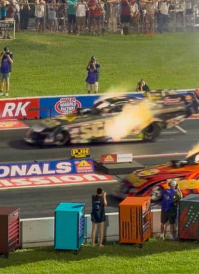 fire exploding from race cars at starting line of NHRA US Nationals.